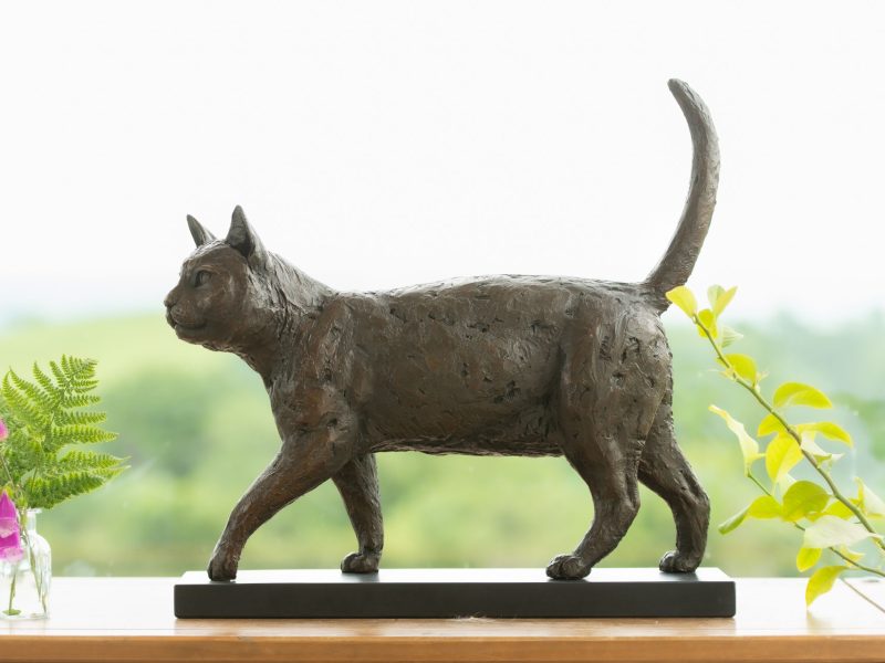 Side view of a cat ornament on a windowsill